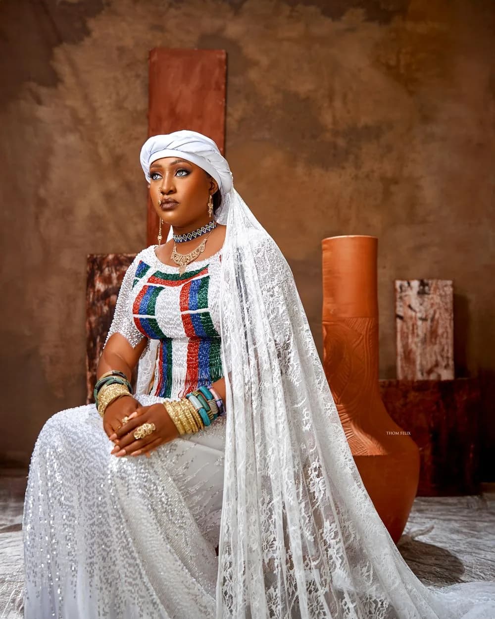 Sefiya Diejomaoh seated in a beaded blouse and lace veil